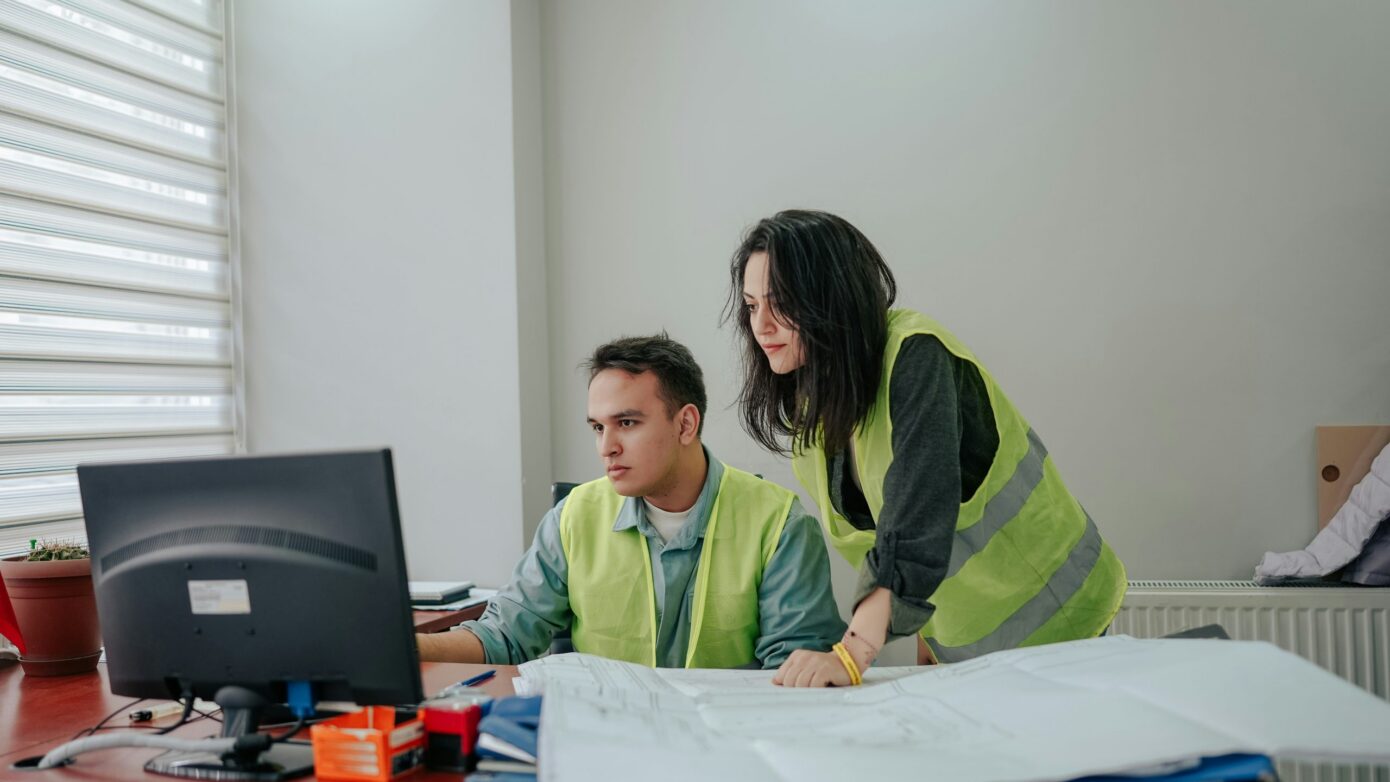 people working at a computer in an office